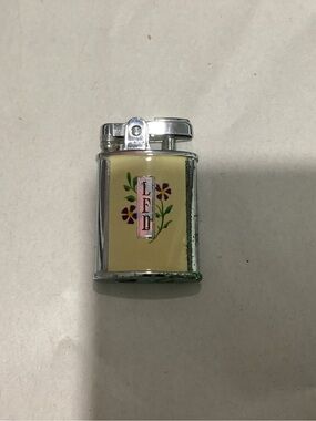 TG. Ronson Gem or Princess pocket lighter with floral emblem design